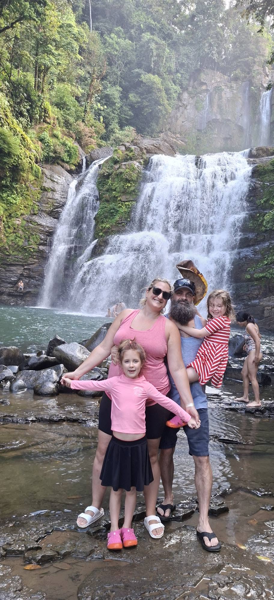 Family enjoying a Costa Rica waterfall adventure